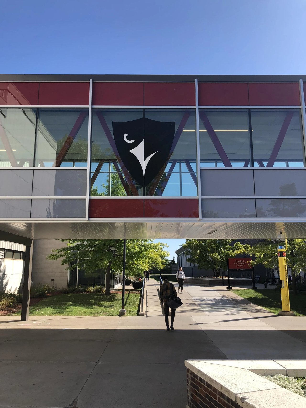 Campus-Gebäude mit Carleton-Logo, grüne Umgebung der Carleton University, Ottawa, Kanada.